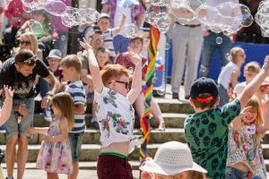 Children trying to catch soap bubbles photo