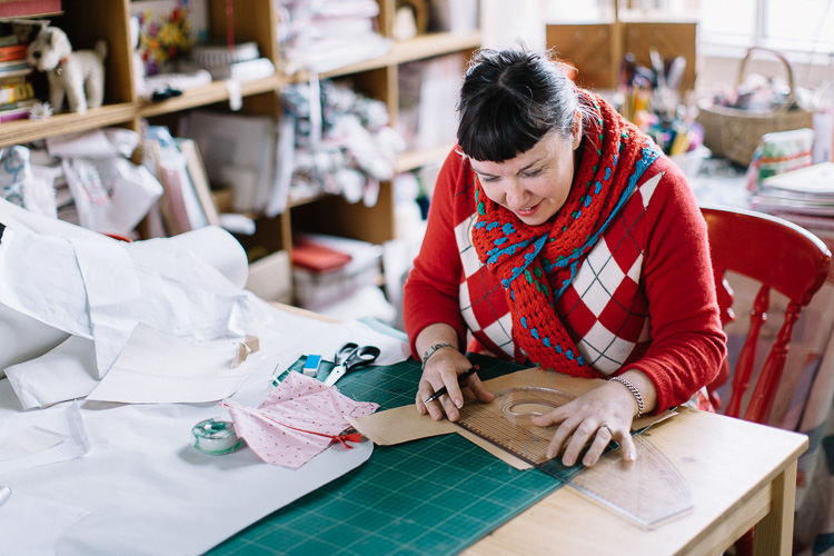 Leah Halliday, designer and dressmaker, cuts a pattern at her So Sew Pretty workshop premises