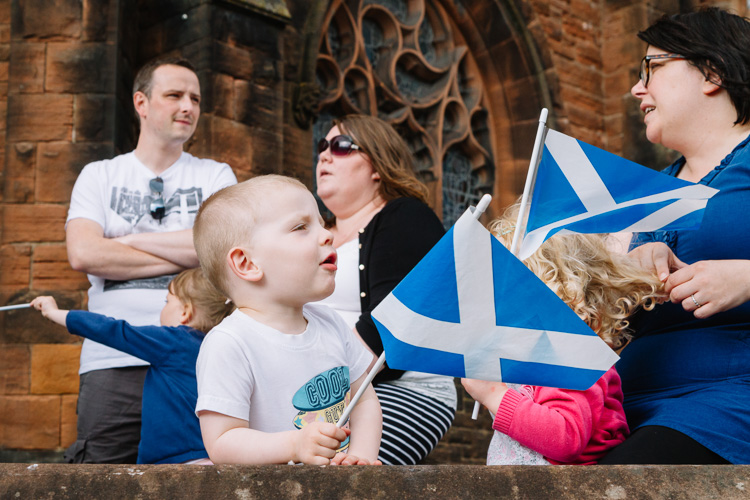 Spectators with Saltire flags at the annual Guid Nichburris festival float parade