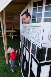 Father and son playign with Hugh Bryden's model of the Lyceum, a preview of the upcoming "Forgotten Doors" exhibition
