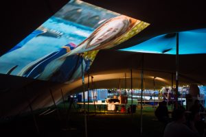Film projections related to the river on the walls of Nithraid tent