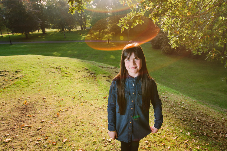 Autumnal portrait of a girl with a flare
