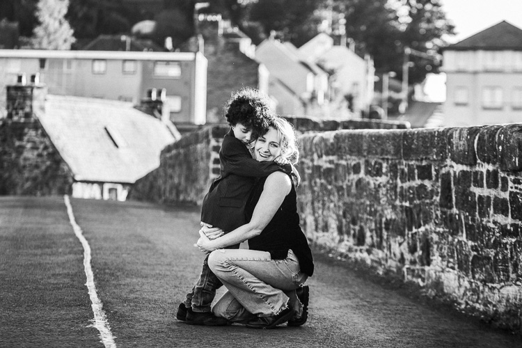Mother and son hugging on Devorgilla Bridge