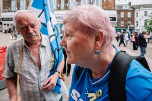 Pro-independence merchadise - a woman shows her patriotic earrings to me