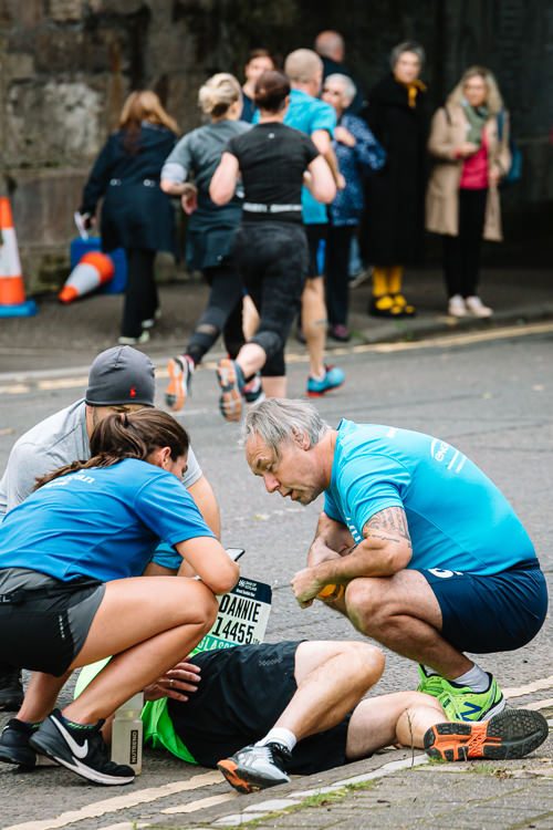 Calling for medical help as one of the runners falls