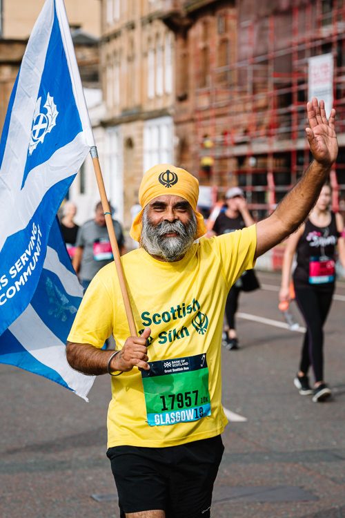 A Scottish Sikh runner with a saltire flag
