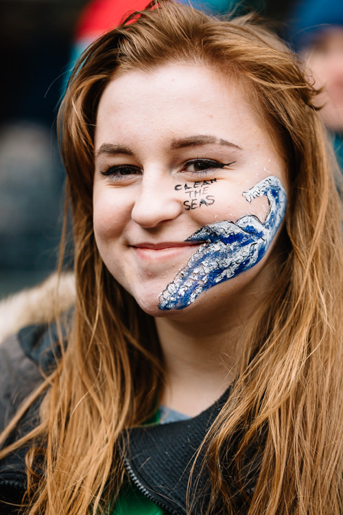 Greenpeace campaigner with Clean the Seas and Blue Wave face paint