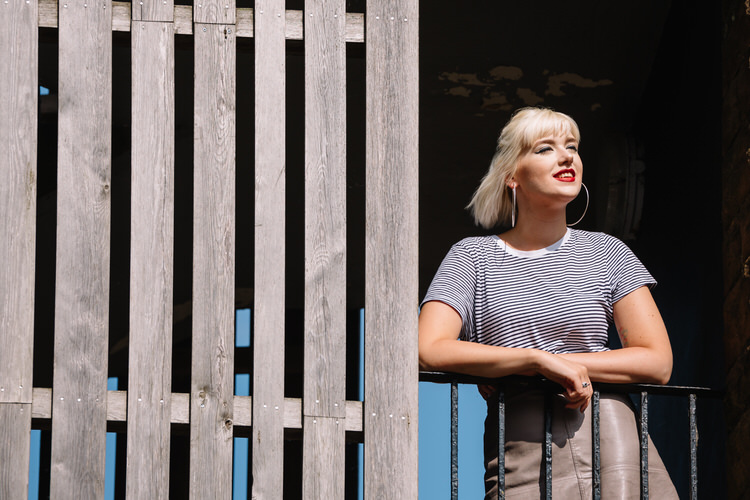 Wooden cladding stripes, metal balusters and hand-railing  used to enhance Emily's urban portraits