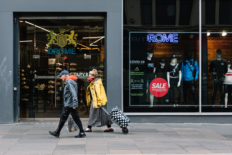 Shoppers walking outside Dromemensware shop on Argyle Street