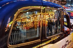 Xmas carousel reflected in the taxi outside George Square, Glasgow
